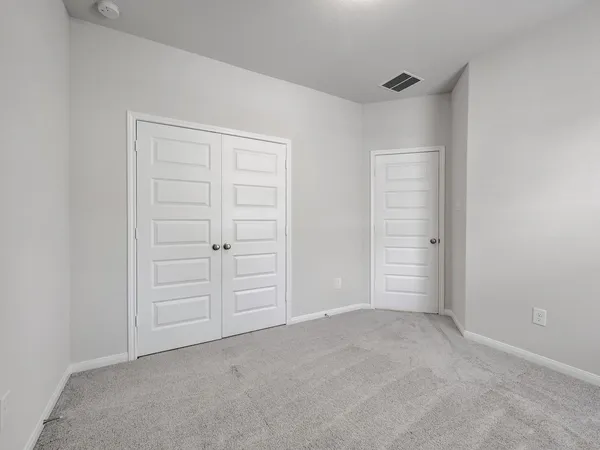 an empty room with closet area