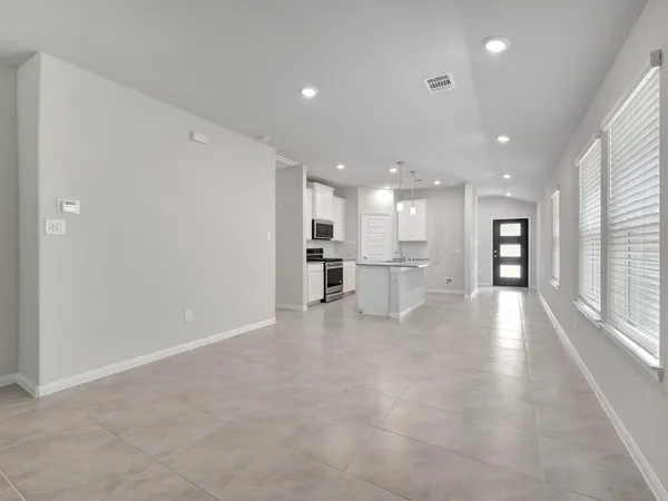 a view of a kitchen with a refrigerator and a window