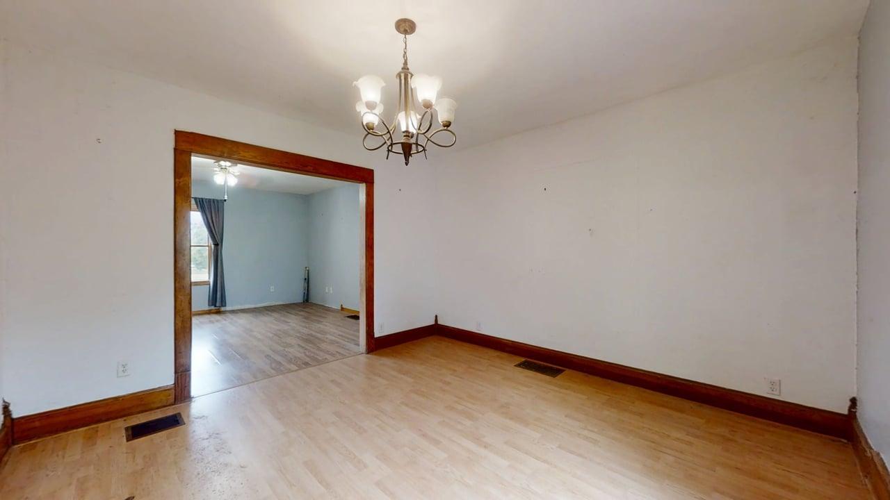 320 North Main Street Gifford, IL 61847 - Photo 15 of 42 a view of a room with wooden floor and chandelier