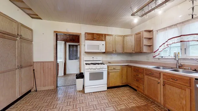 a kitchen with stainless steel appliances granite countertop a sink and cabinets