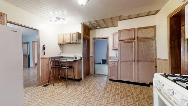a kitchen with stainless steel appliances granite countertop a refrigerator and a stove top oven