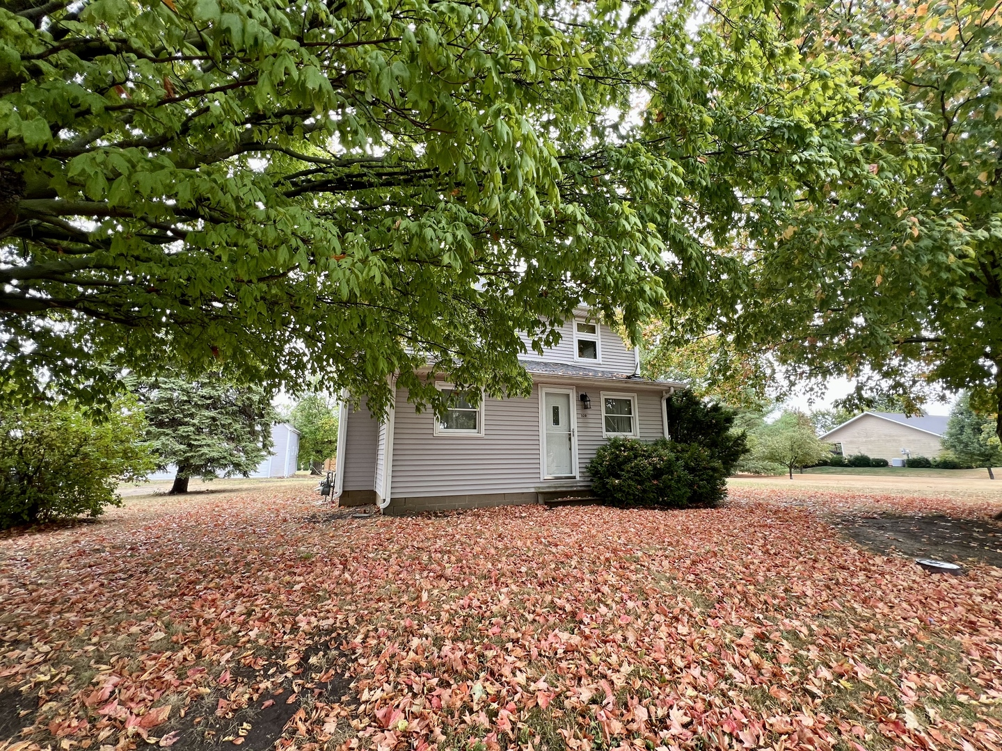 320 North Main Street Gifford, IL 61847 - Photo 2 of 42 a front view of a house with a yard and trees