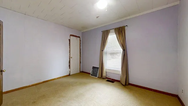 a view of room with window and a ceiling fan