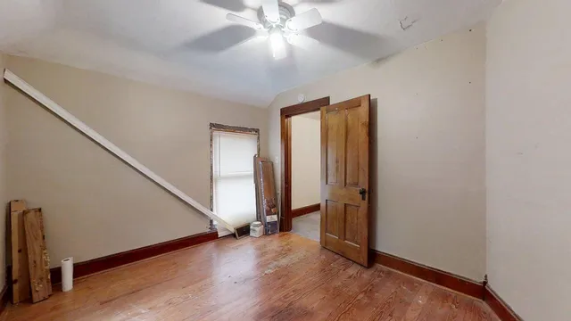 an entryway at a hallway with a window and wooden floor
