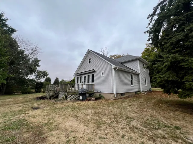 a view of a house with a yard and tree s