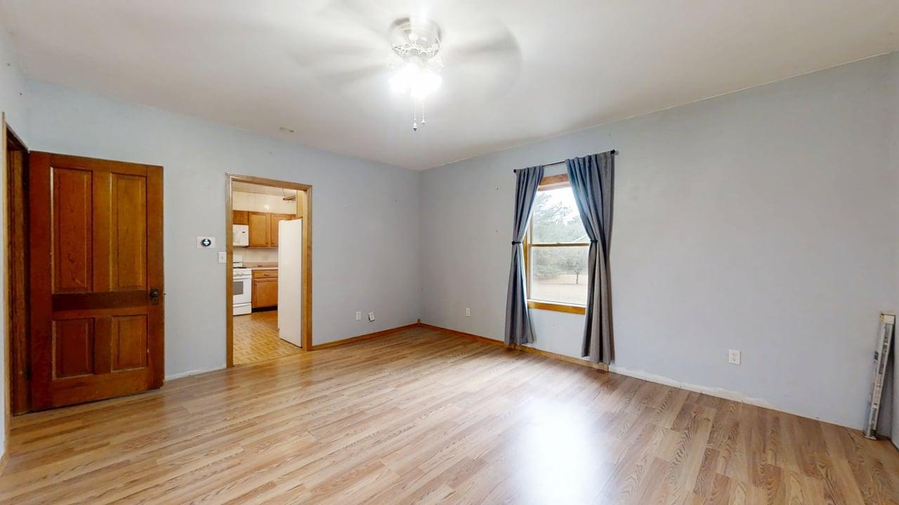 320 North Main Street Gifford, IL 61847 - Photo 7 of 42 an empty room with wooden floor and closet