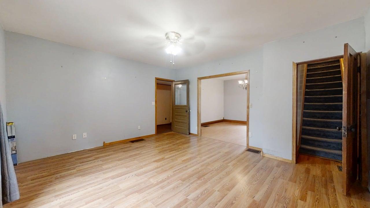 320 North Main Street Gifford, IL 61847 - Photo 9 of 42 a view of an empty room with wooden floor and a window