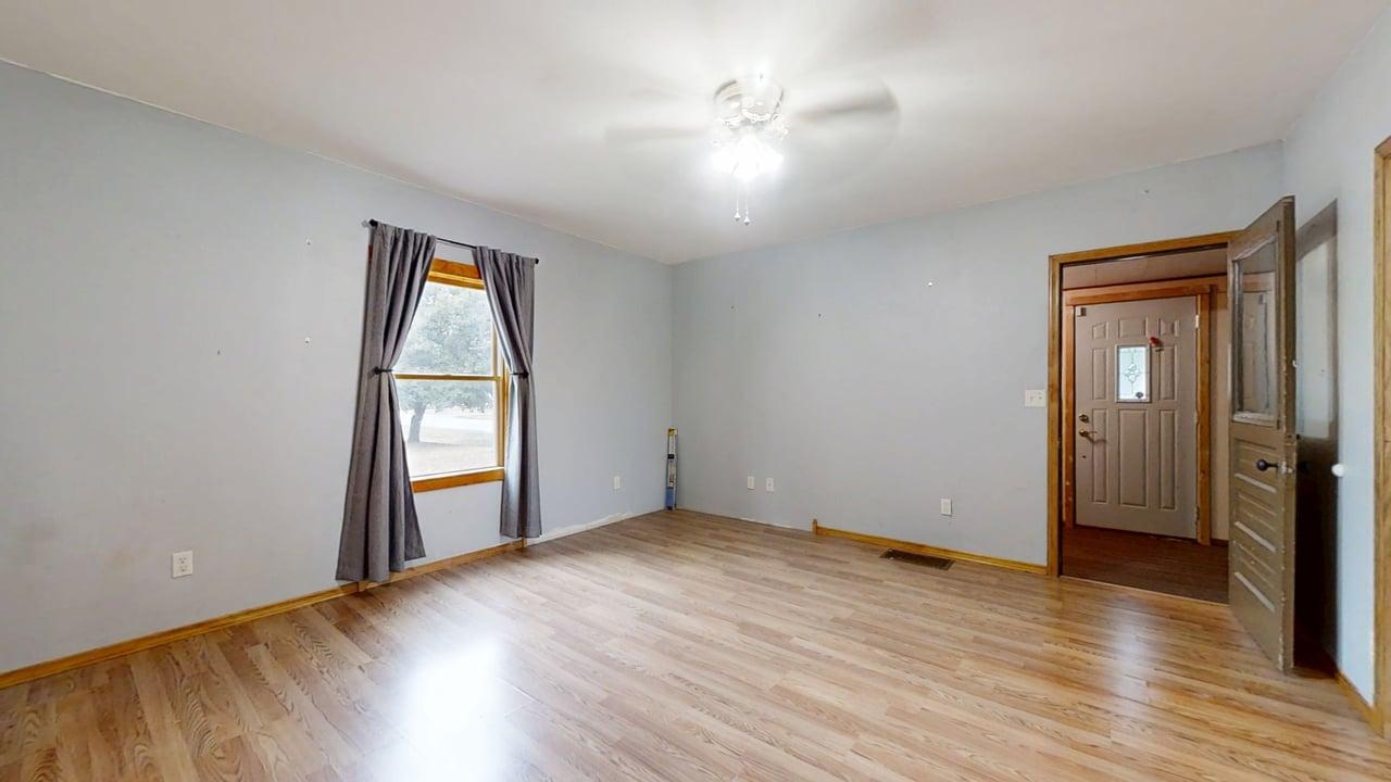 320 North Main Street Gifford, IL 61847 - Photo 10 of 42 an empty room with wooden floor and windows