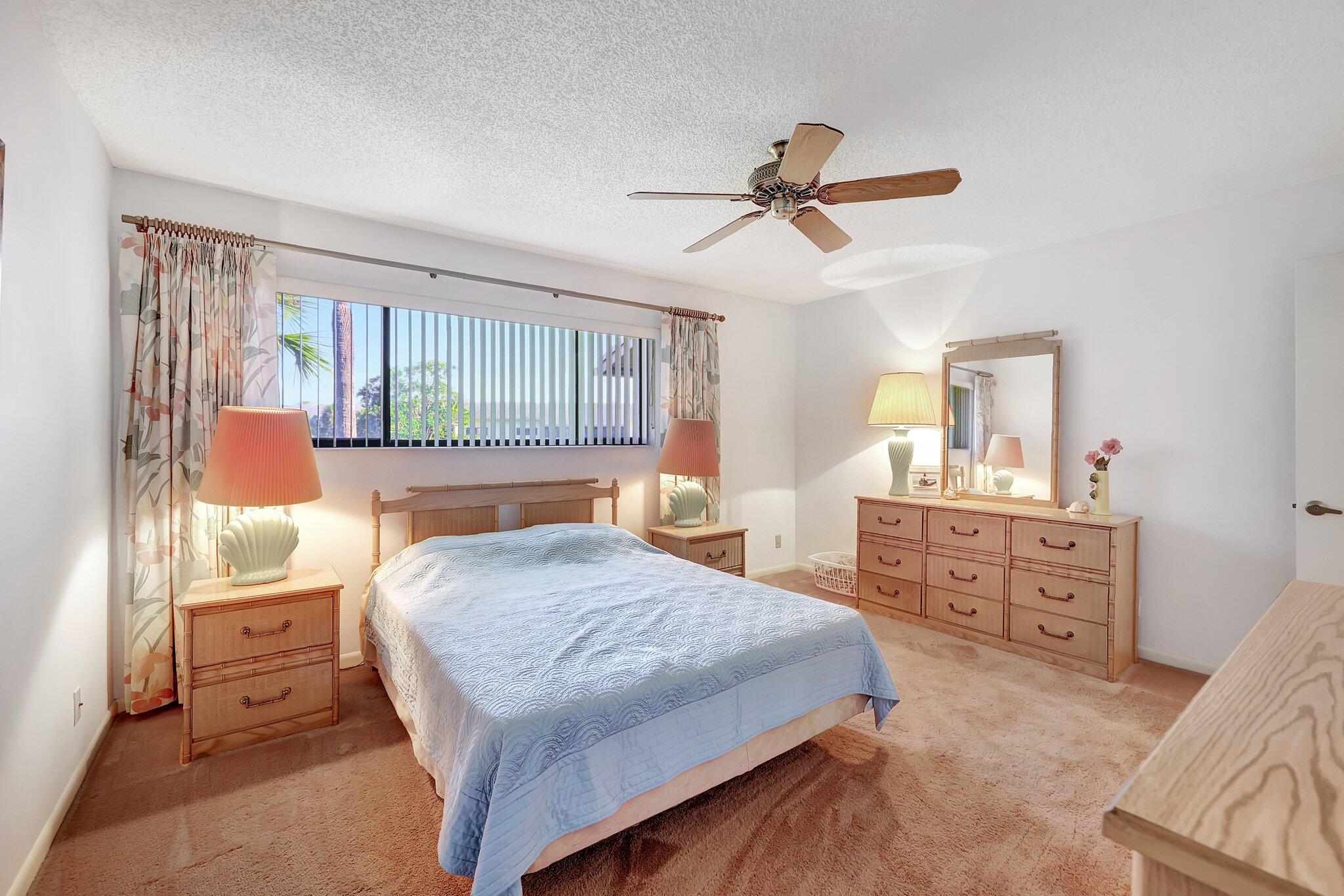 3001 Southeast Aster Lane, Unit 906 Stuart, FL 34994 - Photo 16 of 24 a bedroom with a bed and a dresser