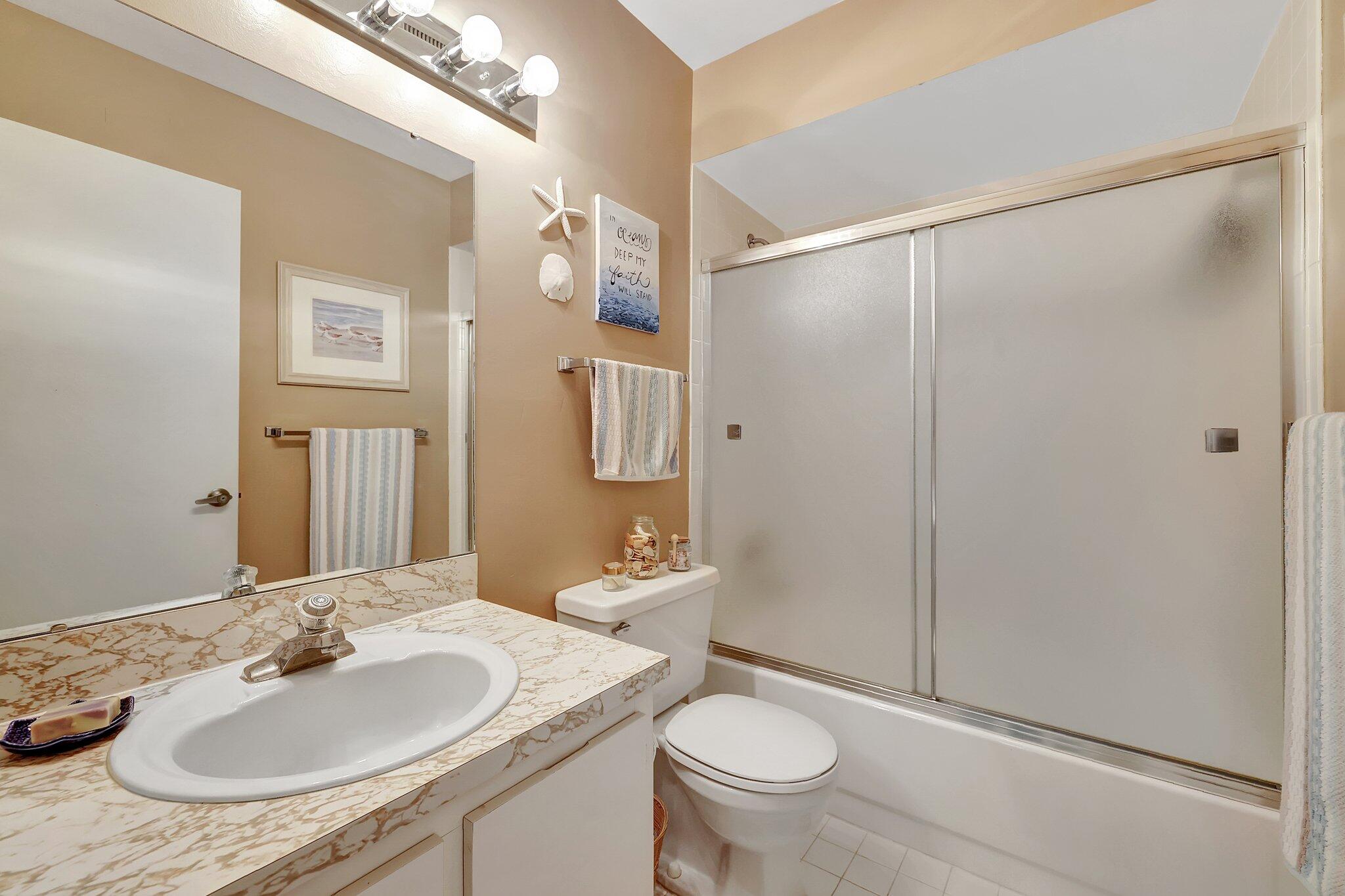 3001 Southeast Aster Lane, Unit 906 Stuart, FL 34994 - Photo 19 of 24 a bathroom with a sink and a mirror