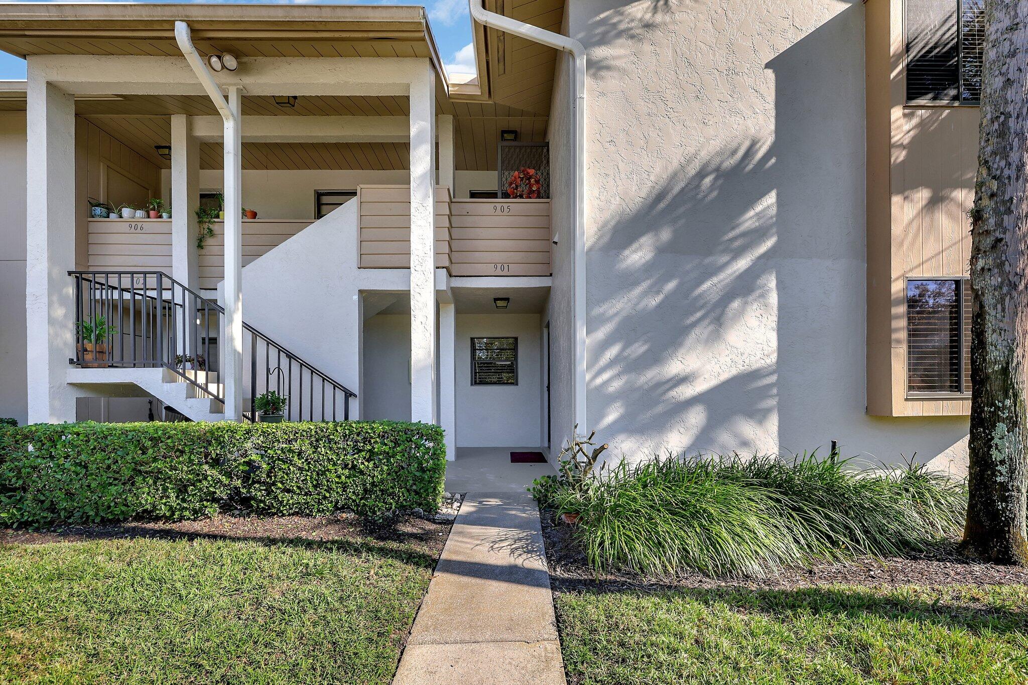 3001 Southeast Aster Lane, Unit 906 Stuart, FL 34994 - Photo 24 of 24 front view of a house with a yard