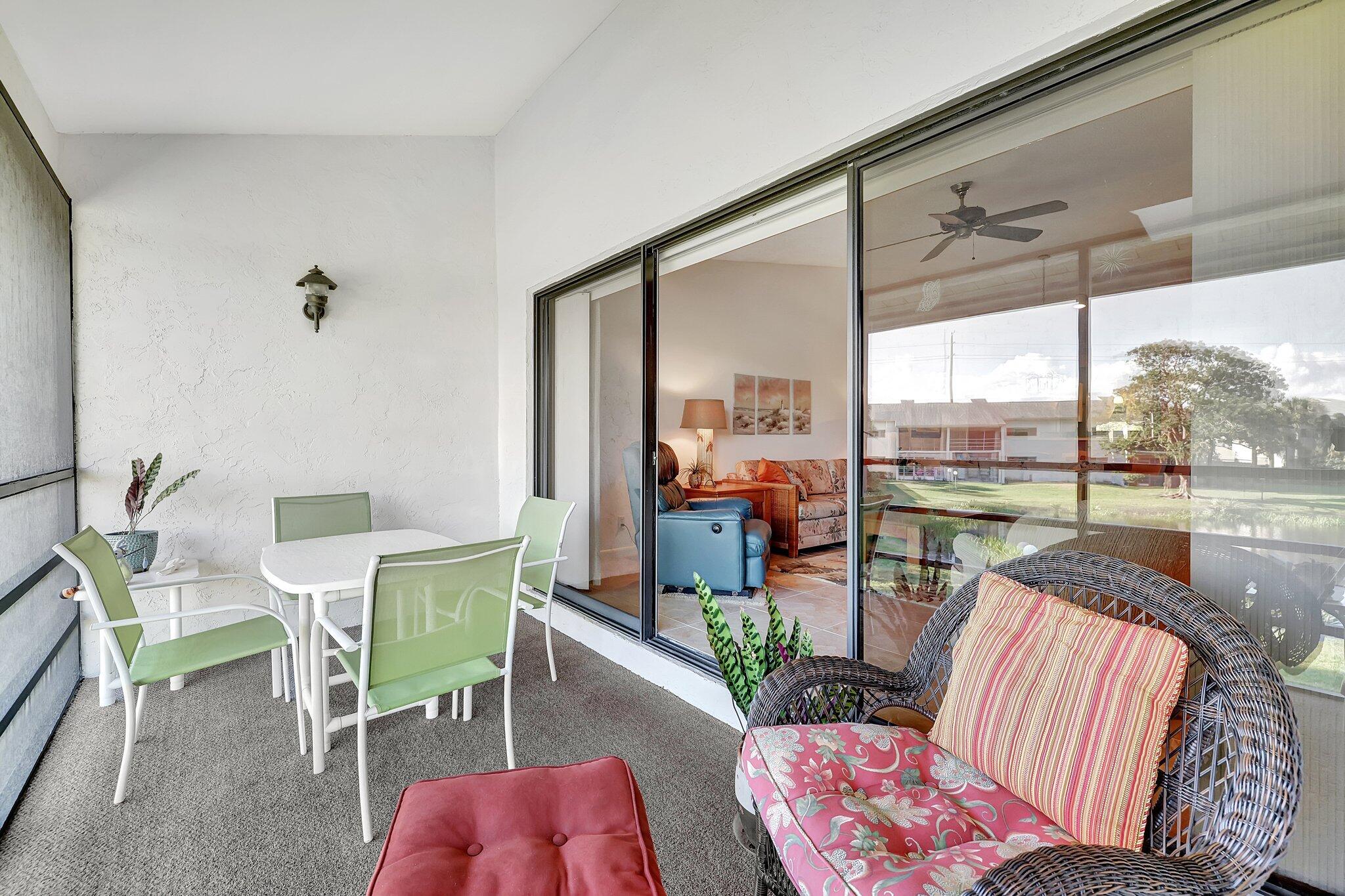 3001 Southeast Aster Lane, Unit 906 Stuart, FL 34994 - Photo 4 of 24 a living room with furniture and a large window