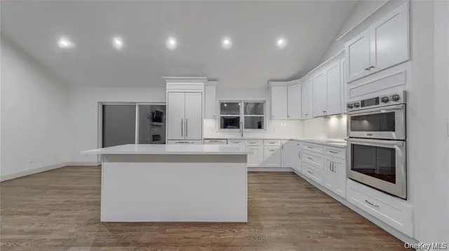 a kitchen with stainless steel appliances granite countertop a stove and a sink