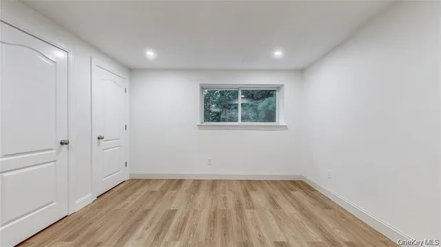 a large kitchen with white cabinets and stainless steel appliances