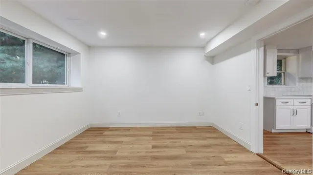 a kitchen with white cabinets and appliances
