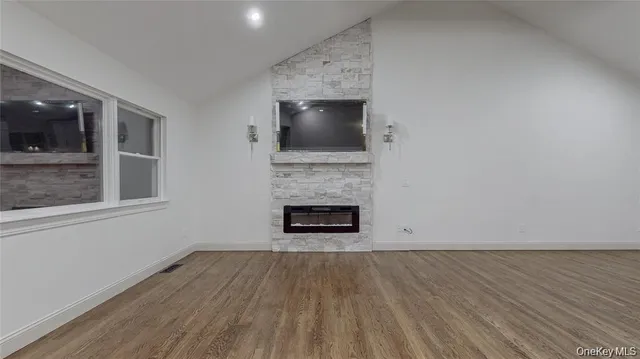 a living room with a fireplace and a flat screen tv