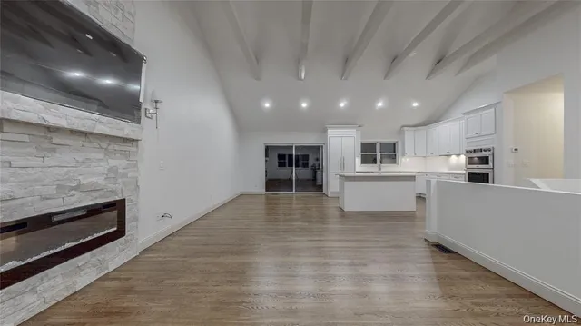 a view of kitchen with kitchen island granite countertop a stove and a refrigerator