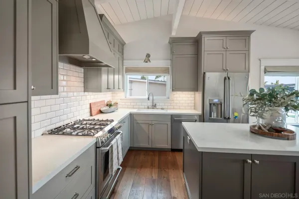 a kitchen with a sink stove and refrigerator