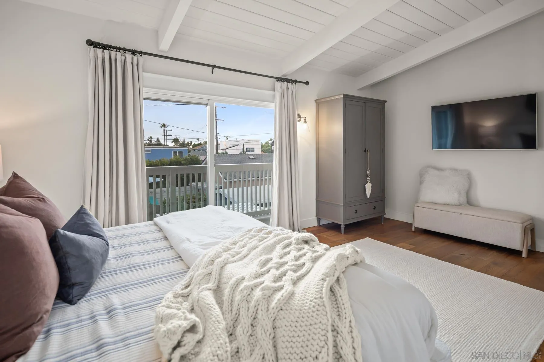 420 1st Street Coronado, CA 92118 - Photo 19 of 38 a bedroom with a large bed and a flat screen tv