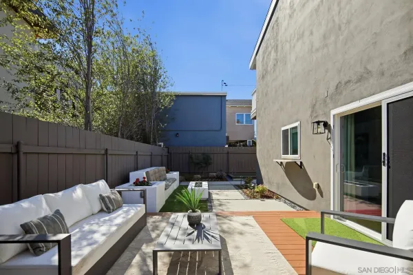 a view of a patio with a table and chairs