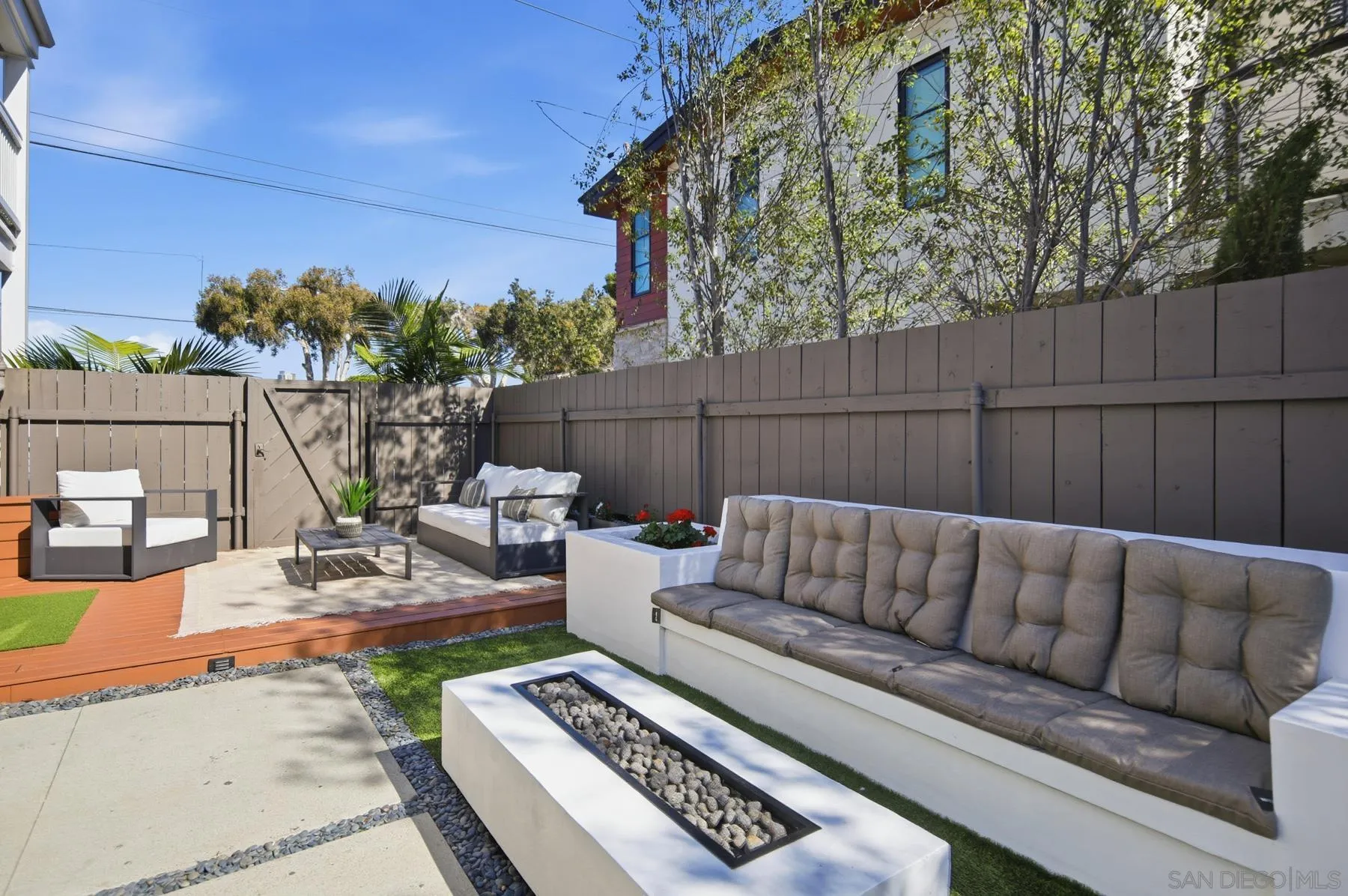 420 1st Street Coronado, CA 92118 - Photo 31 of 38 a view of a backyard with couches table and chairs with wooden fence
