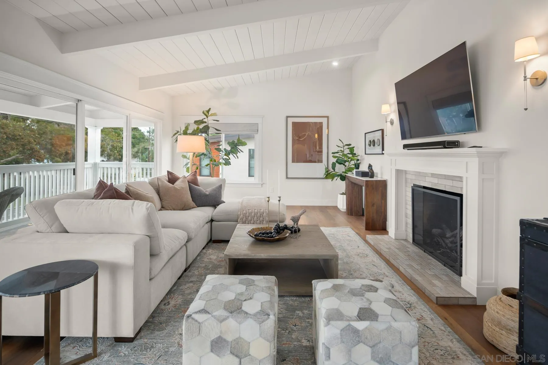420 1st Street Coronado, CA 92118 - Photo 5 of 38 a living room with furniture a fireplace and a flat screen tv