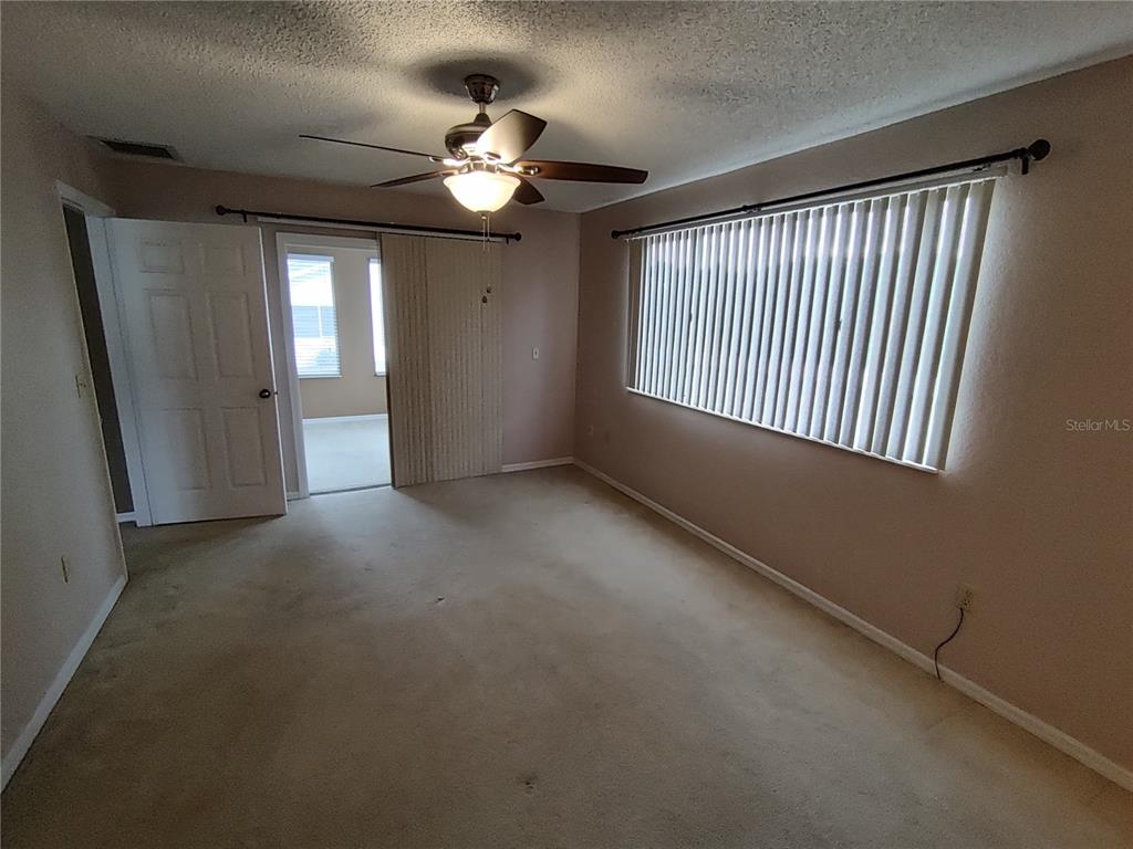 8792 Southwest 116th Place Road Ocala, FL 34481 - Photo 25 of 36 a view of an empty room with a window