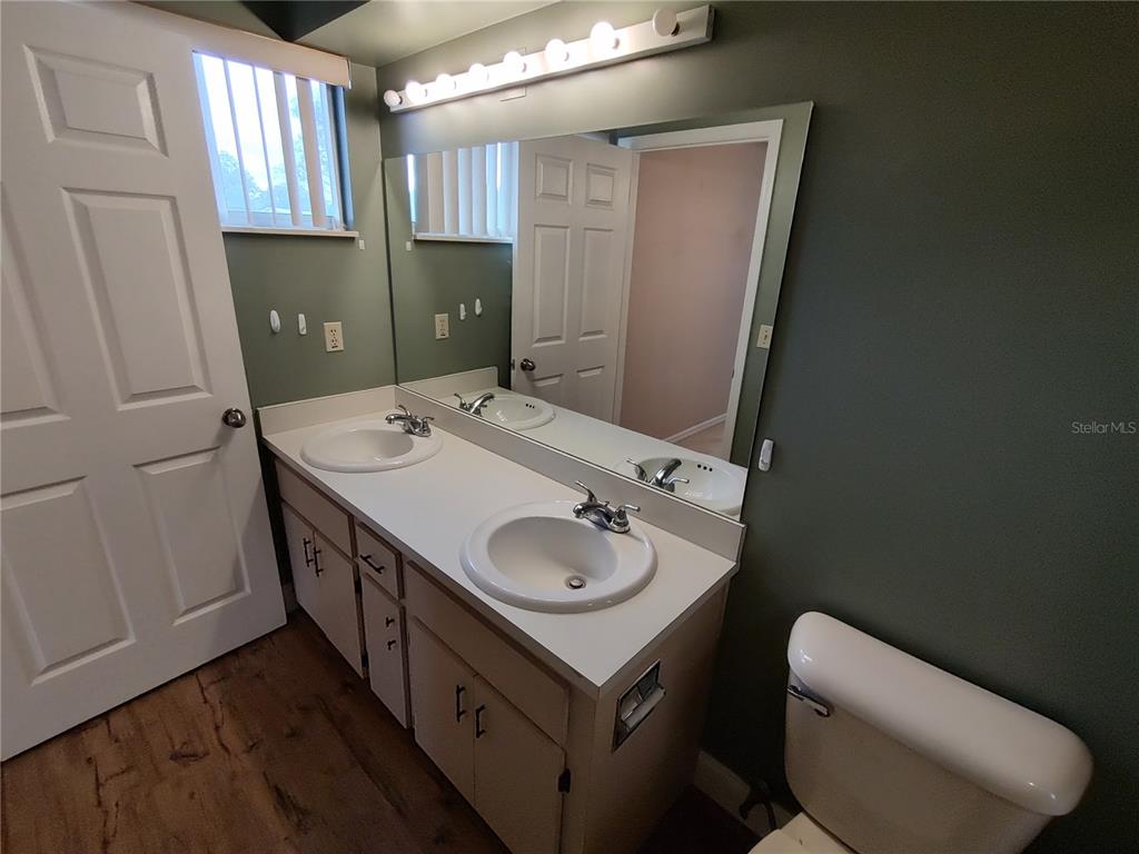 8792 Southwest 116th Place Road Ocala, FL 34481 - Photo 28 of 36 a bathroom with a granite countertop sink toilet and mirror