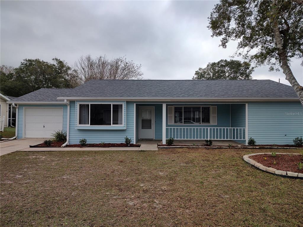 8792 Southwest 116th Place Road Ocala, FL 34481 - Photo 4 of 36 a front view of a house with a yard