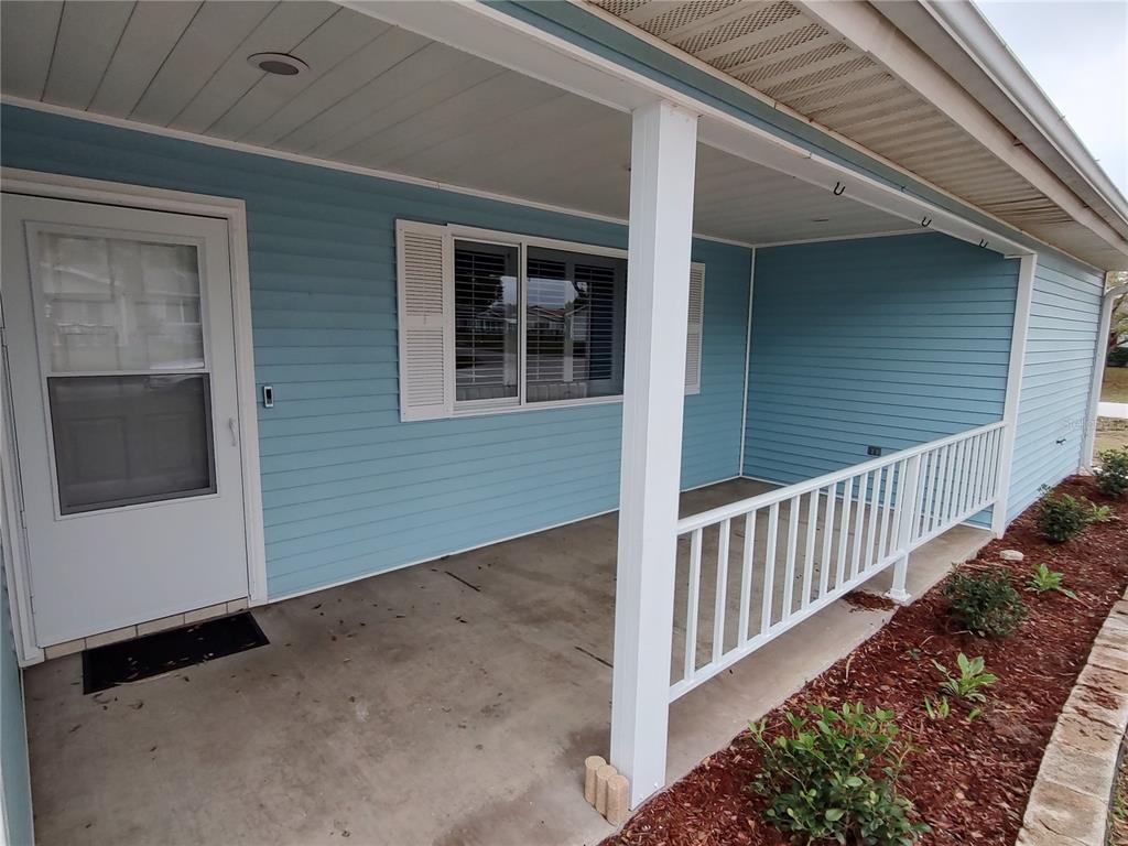 8792 Southwest 116th Place Road Ocala, FL 34481 - Photo 6 of 36 a view of a porch with wooden floor and fence