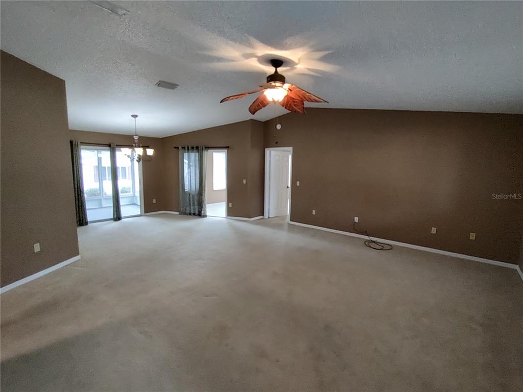 8792 Southwest 116th Place Road Ocala, FL 34481 - Photo 8 of 36 a view of an empty room with a fan