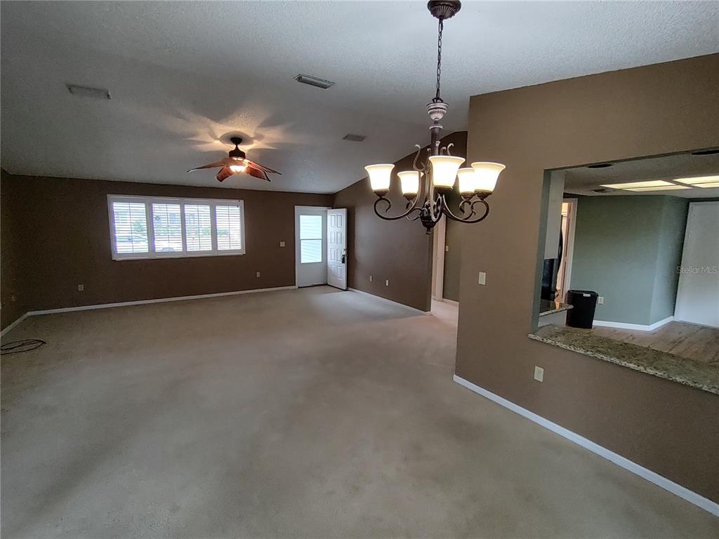 8792 Southwest 116th Place Road Ocala, FL 34481 - Photo 10 of 36 a view of a livingroom with a chandelier furniture and windows
