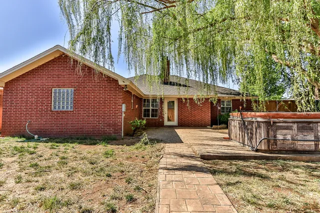 a backyard of a house with yard and outdoor seating