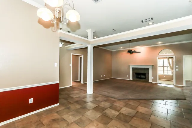 a view of an empty room with a fireplace