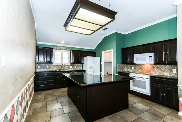 a kitchen with stainless steel appliances granite countertop a stove and a sink