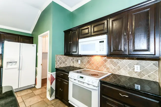 a kitchen with a stove and a microwave