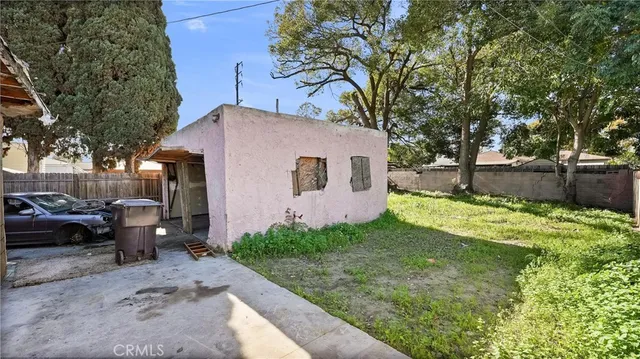 a backyard of a house with table and chairs