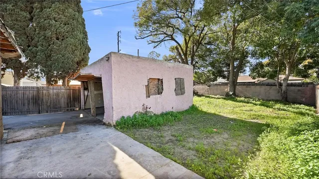 a backyard of a house with wooden fence