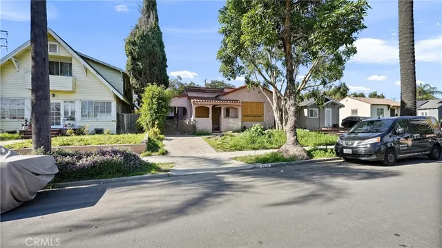 a view of a house with a cars park next to a road