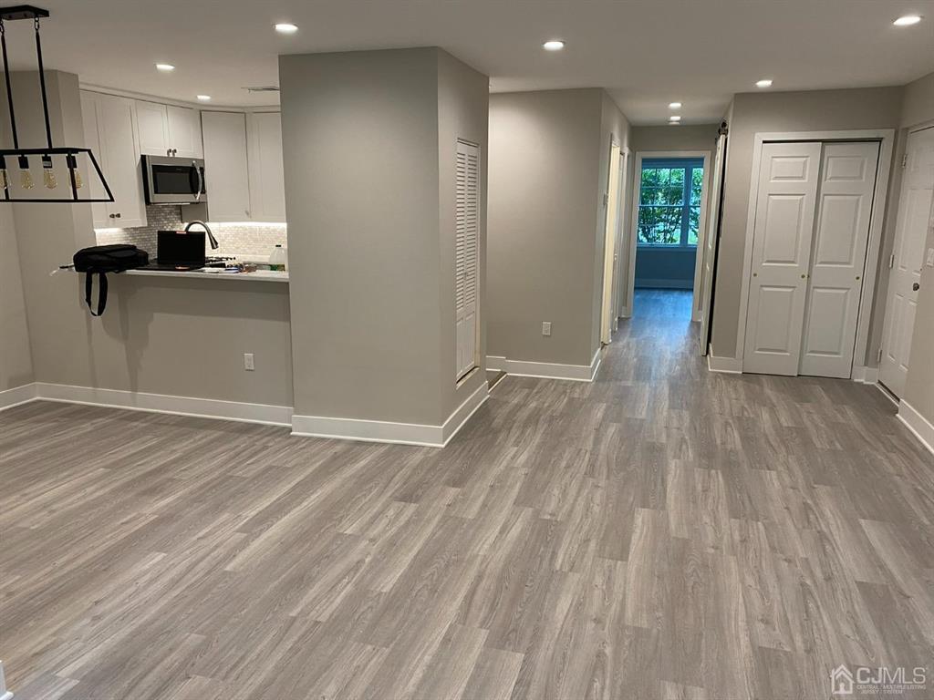 218 Edpas Road New Brunswick, NJ 08901 - Photo 2 of 17 a view of a kitchen with a sink and wooden floor