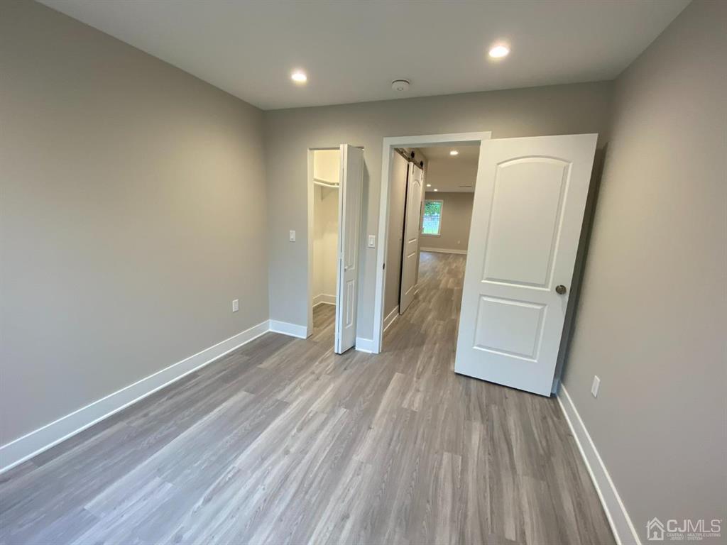 218 Edpas Road New Brunswick, NJ 08901 - Photo 8 of 17 wooden floor in an empty room with a window