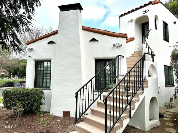 a view of a white house with large windows