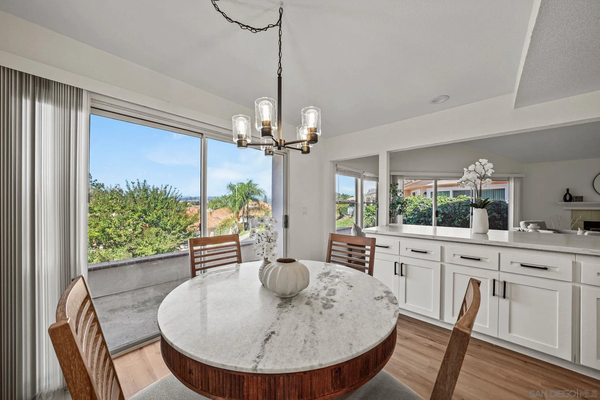 1274 Rue St Moritz San Marcos, CA 92078 - Photo 11 of 39 a dining room with furniture a chandelier and wooden floor