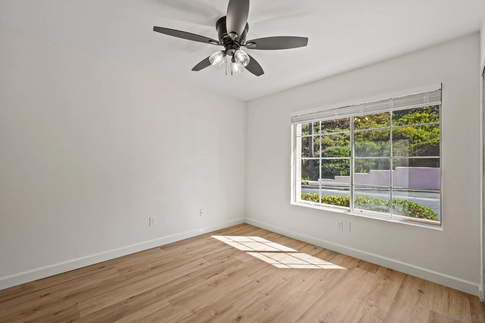 1274 Rue St Moritz San Marcos, CA 92078 - Photo 22 of 39 a view of an empty room with a window and wooden floor