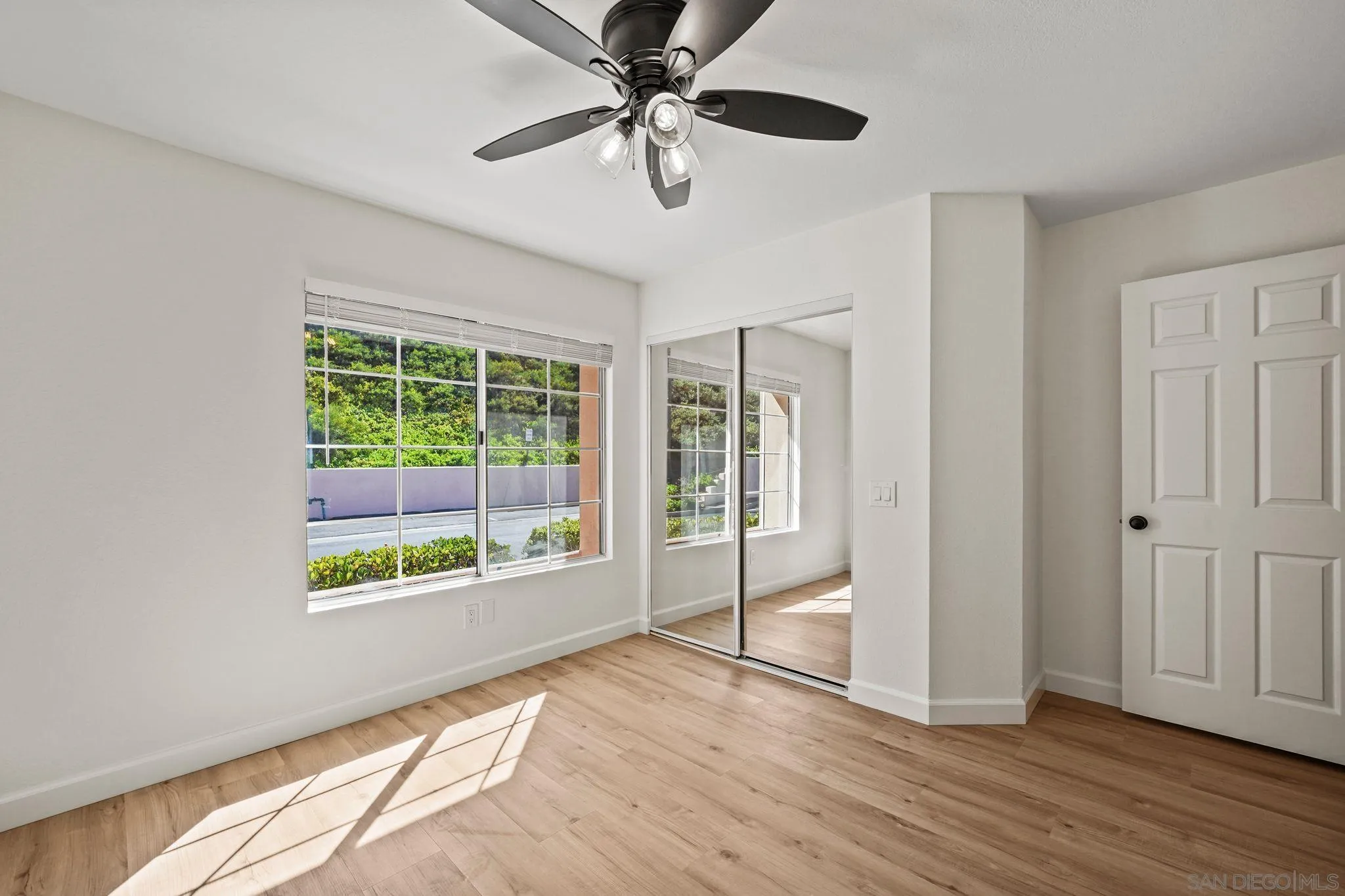 1274 Rue St Moritz San Marcos, CA 92078 - Photo 23 of 39 a view of an empty room with a window and wooden floor