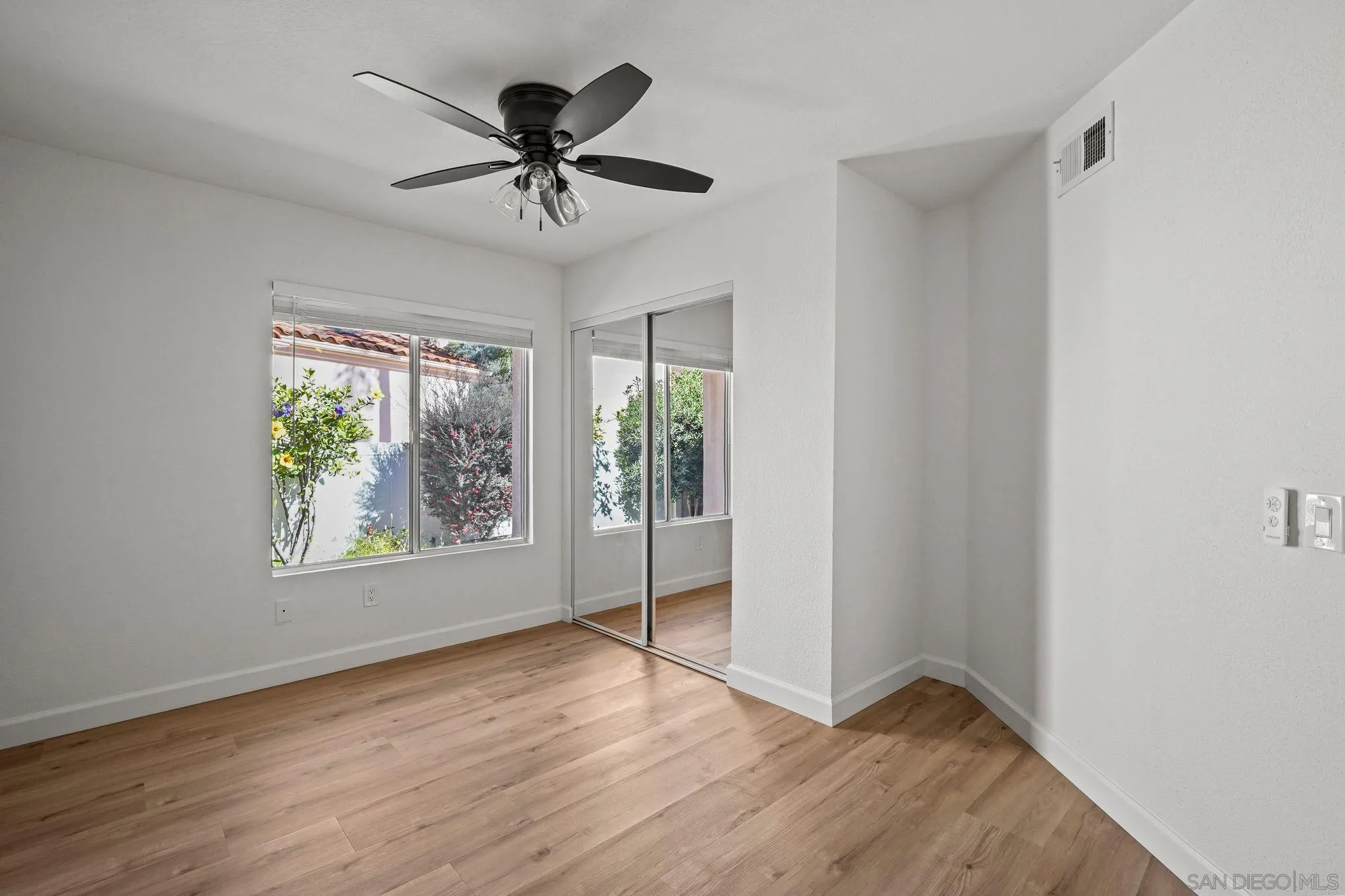 1274 Rue St Moritz San Marcos, CA 92078 - Photo 25 of 39 a view of an empty room with wooden floor and a window