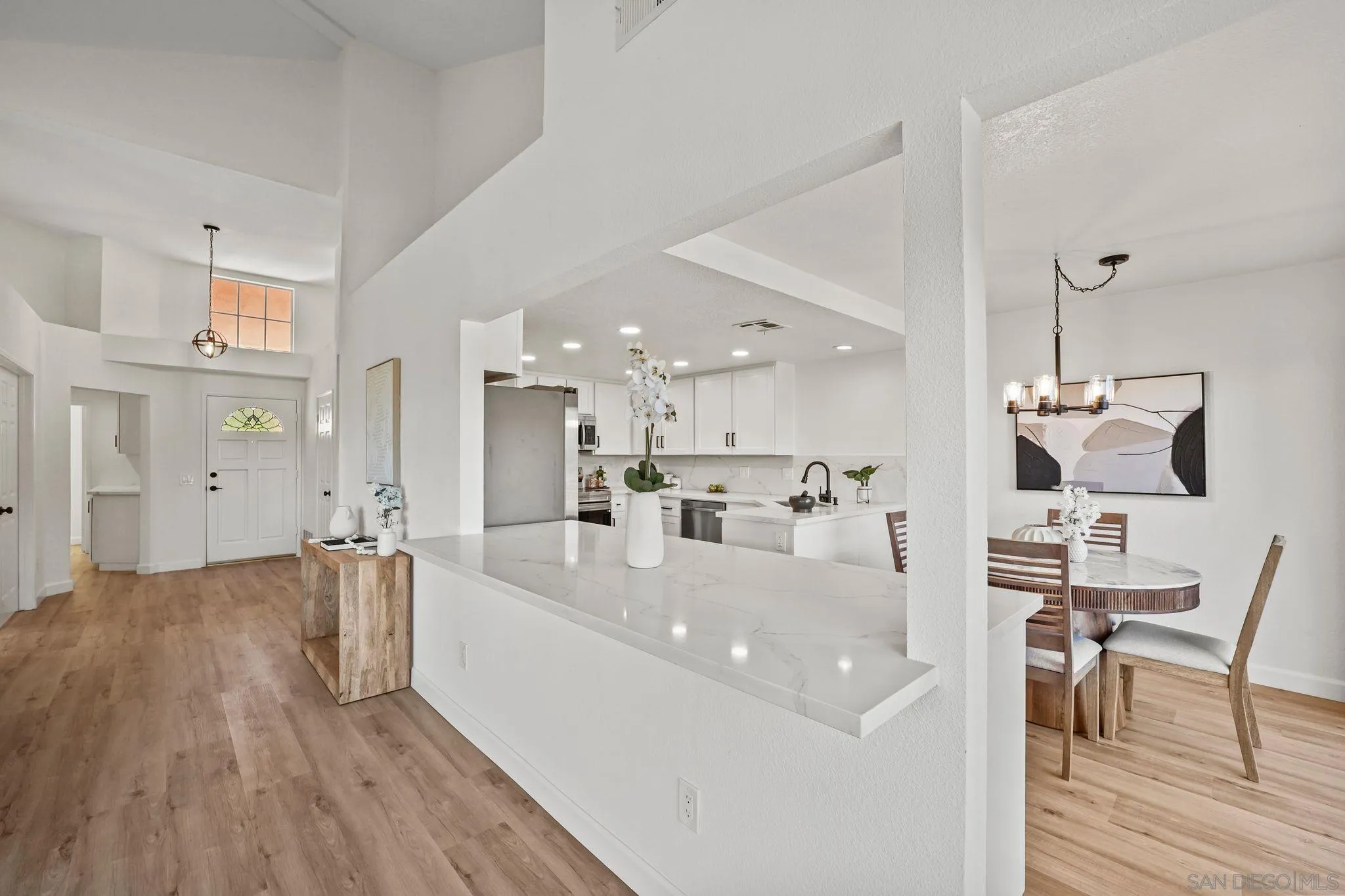 1274 Rue St Moritz San Marcos, CA 92078 - Photo 5 of 39 a large white kitchen with a large counter top appliances and cabinets