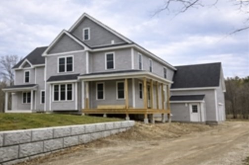 94 Willow Street, Unit 2 Acton, MA 01720 - Photo 23 of 24 a front view of a house with a yard and garage