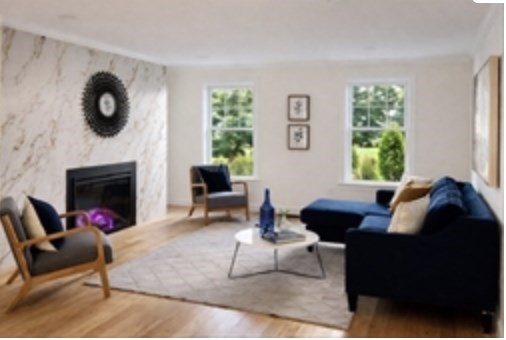 94 Willow Street, Unit 2 Acton, MA 01720 - Photo 7 of 24 a living room with furniture a window and a fireplace