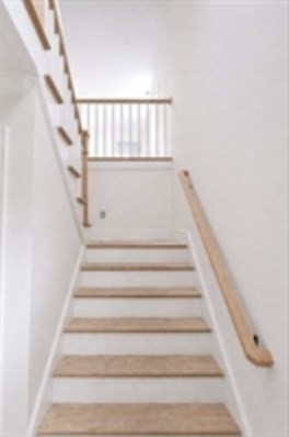 94 Willow Street, Unit 2 Acton, MA 01720 - Photo 10 of 24 a view of staircase with white walls and a rug